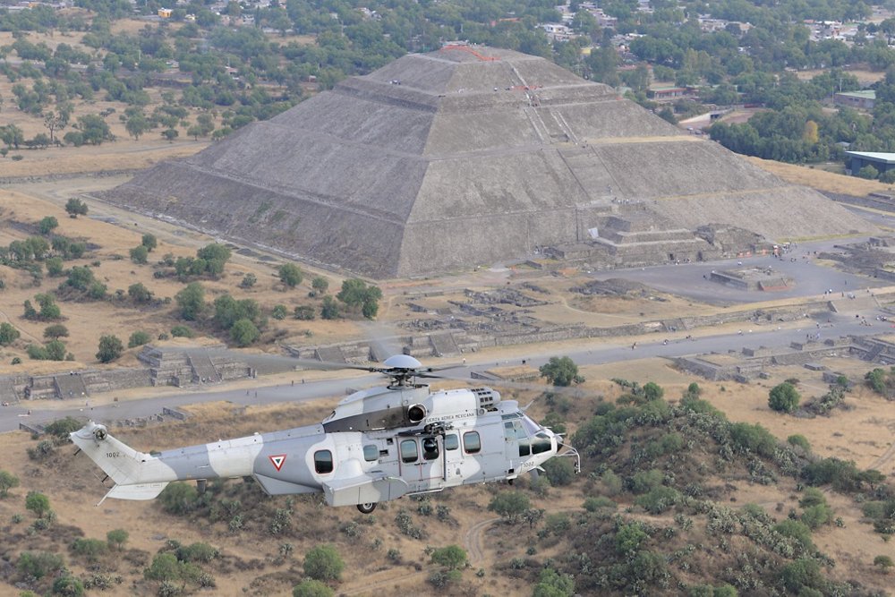 An Airbus H225M military helicopter in service with the Mexican Air Force flies near one of Mexico’s pyramids. 