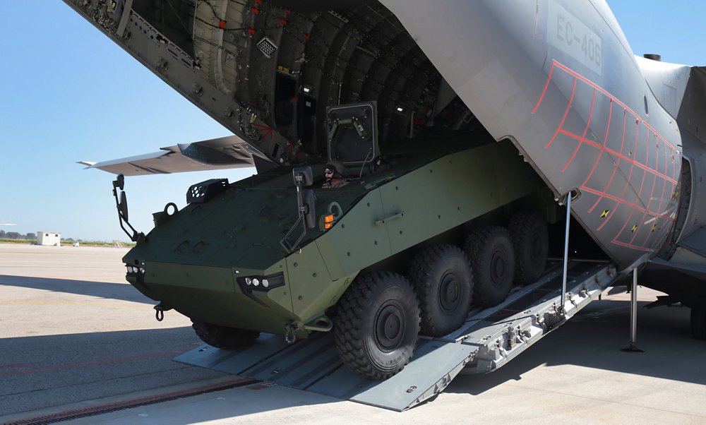 A heavy infantry fighting vehicle is rolled out from an A400M military airlifter’s cargo hold.  