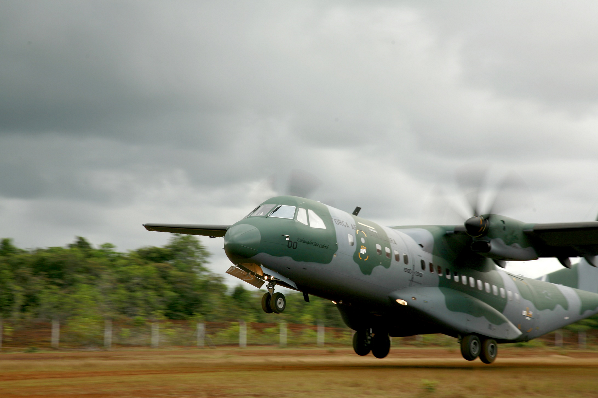 A C295 transport aircraft takes off from a semi-prepared airstrip.   