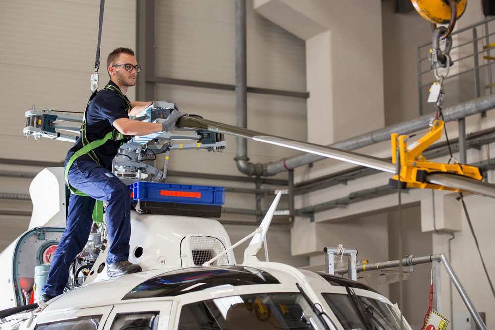 Rotor blade maintenance is performed on an Airbus AS365 N3+ helicopter.