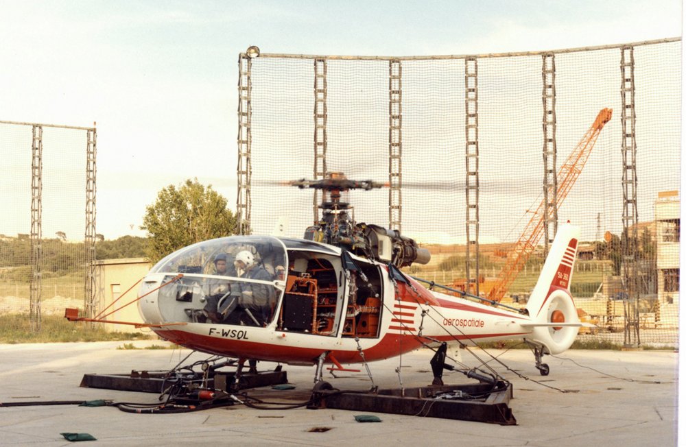 An on-ground photo of the no. 1 SA360 C helicopter, taken in 1972 during engine runup, with rotors turning.   