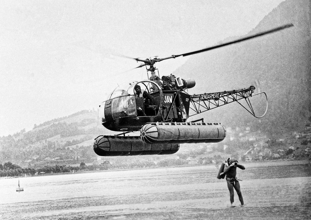 An SE3130 "Alouette II" helicopter is shown during training exercises over Lake Annecy in France.   