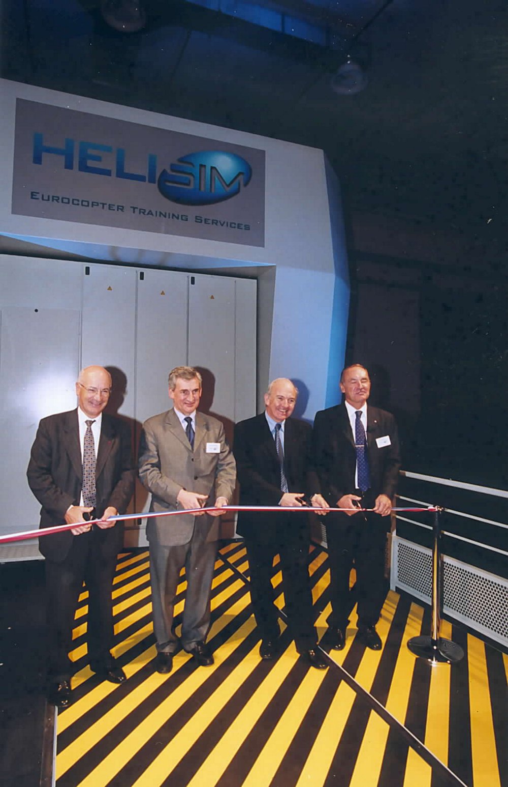 A traditional ribbon cutting during the 2002 inauguration ceremony for Helisim, the simulation centre located at Marseille-Provence International Airport in France. 