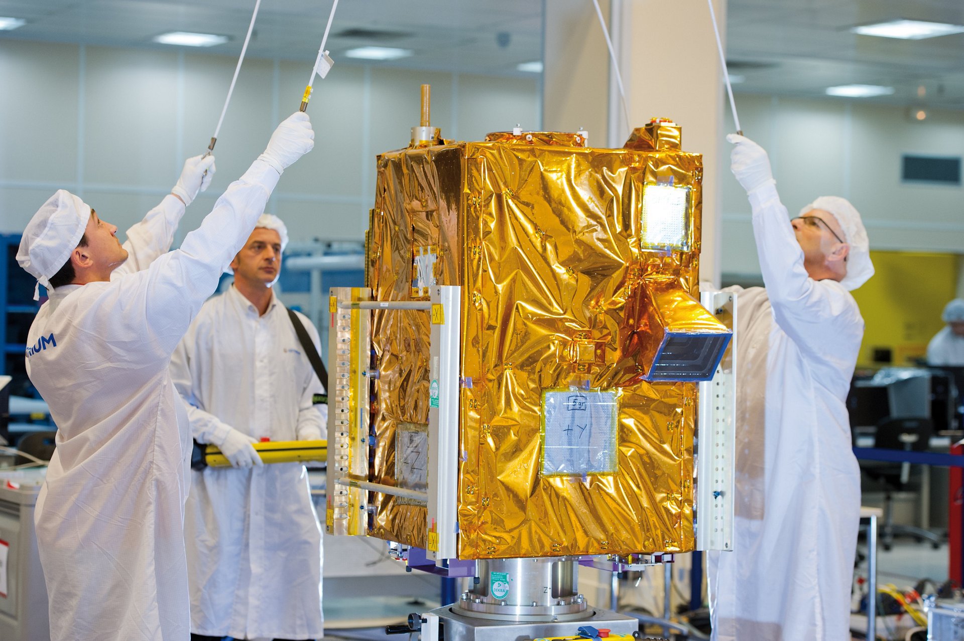 Airbus engineers ready the VNREDSat-1 Earth observation satellite in a clean room setting.  