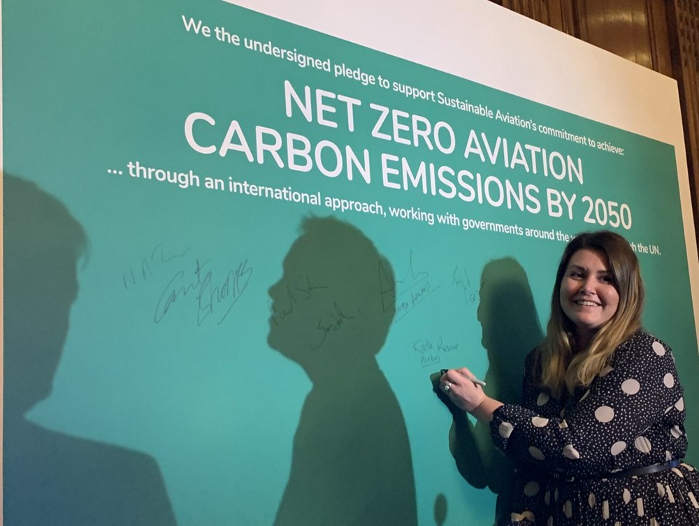 Woman signing table at the Sustainable Aviation Decarbonistion Roadmap launch