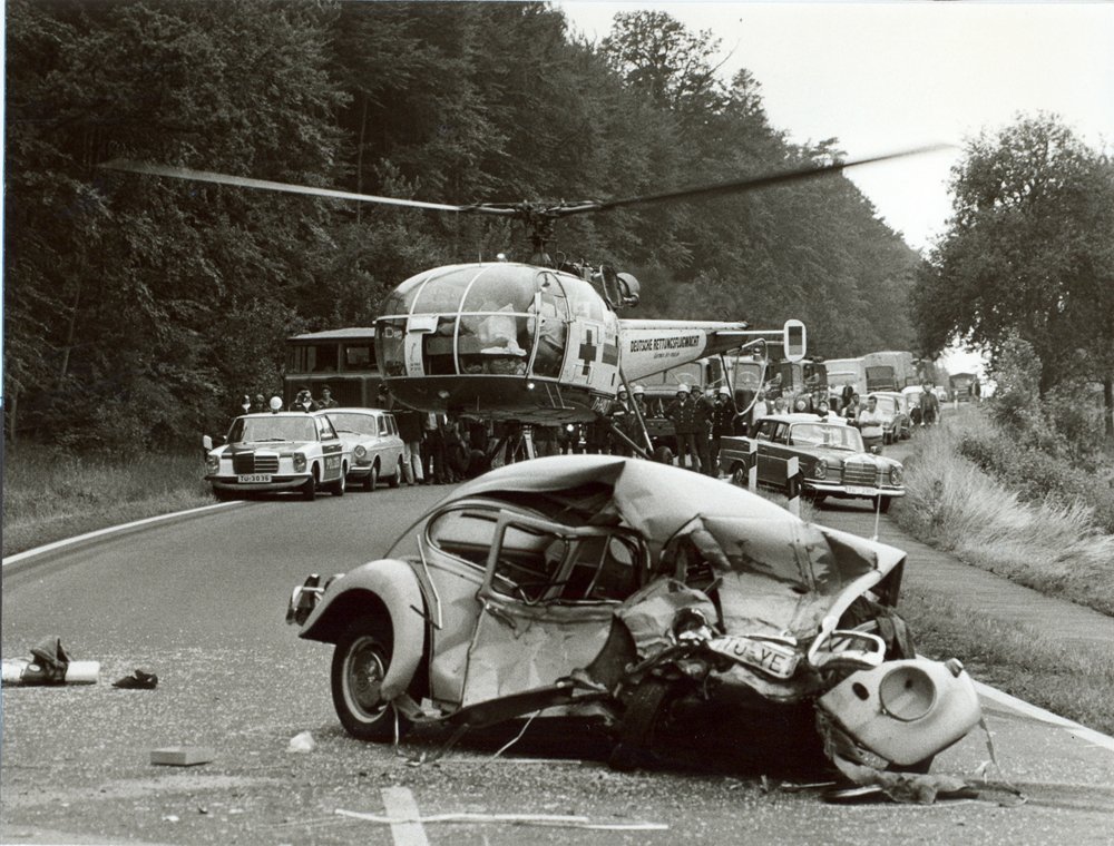 An Alouette III helicopter hovers at a road accident scene in Germany during the 1970s.