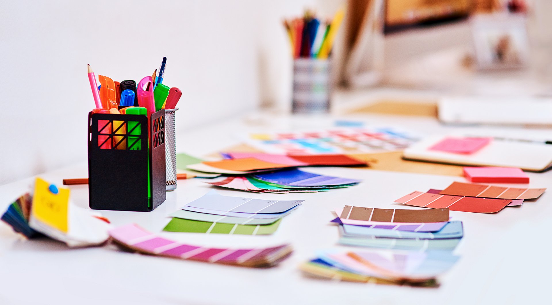 Shot of a notebook and various tools at a creative workstation