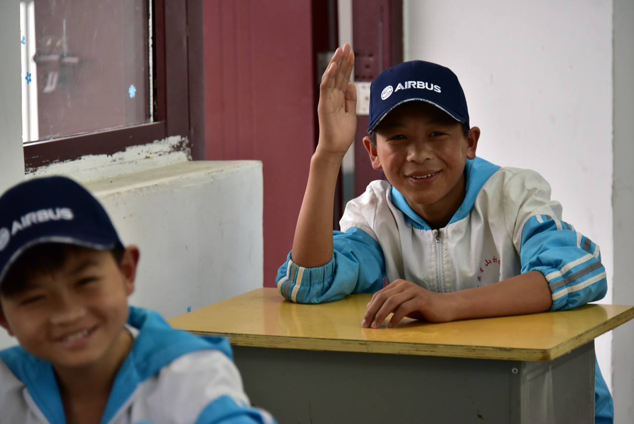 Two smiling students from the Beijing Guang Ai School in China.  