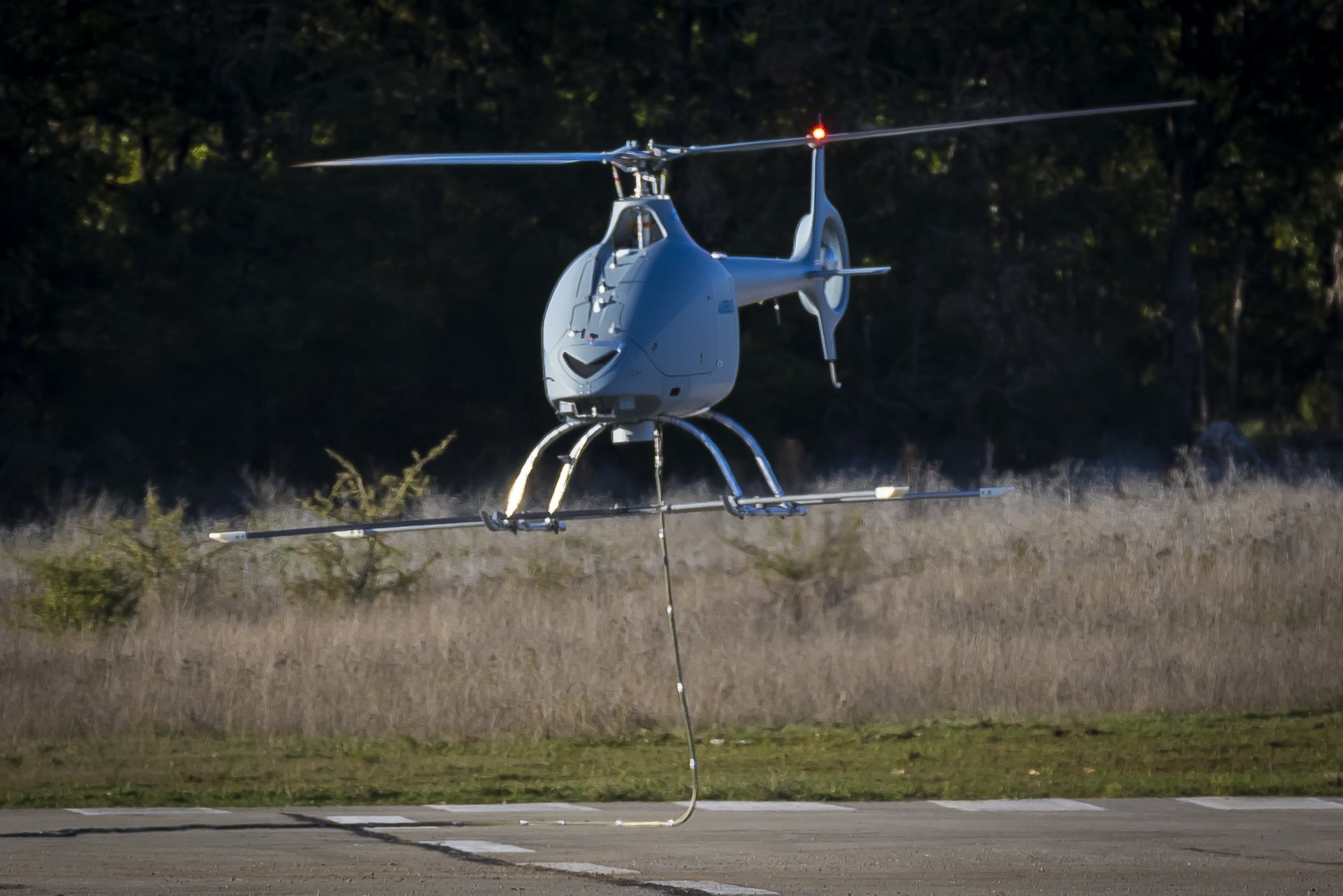 Airbus’ VSR700 multi-mission unmanned aerial system hovers over the ground.  