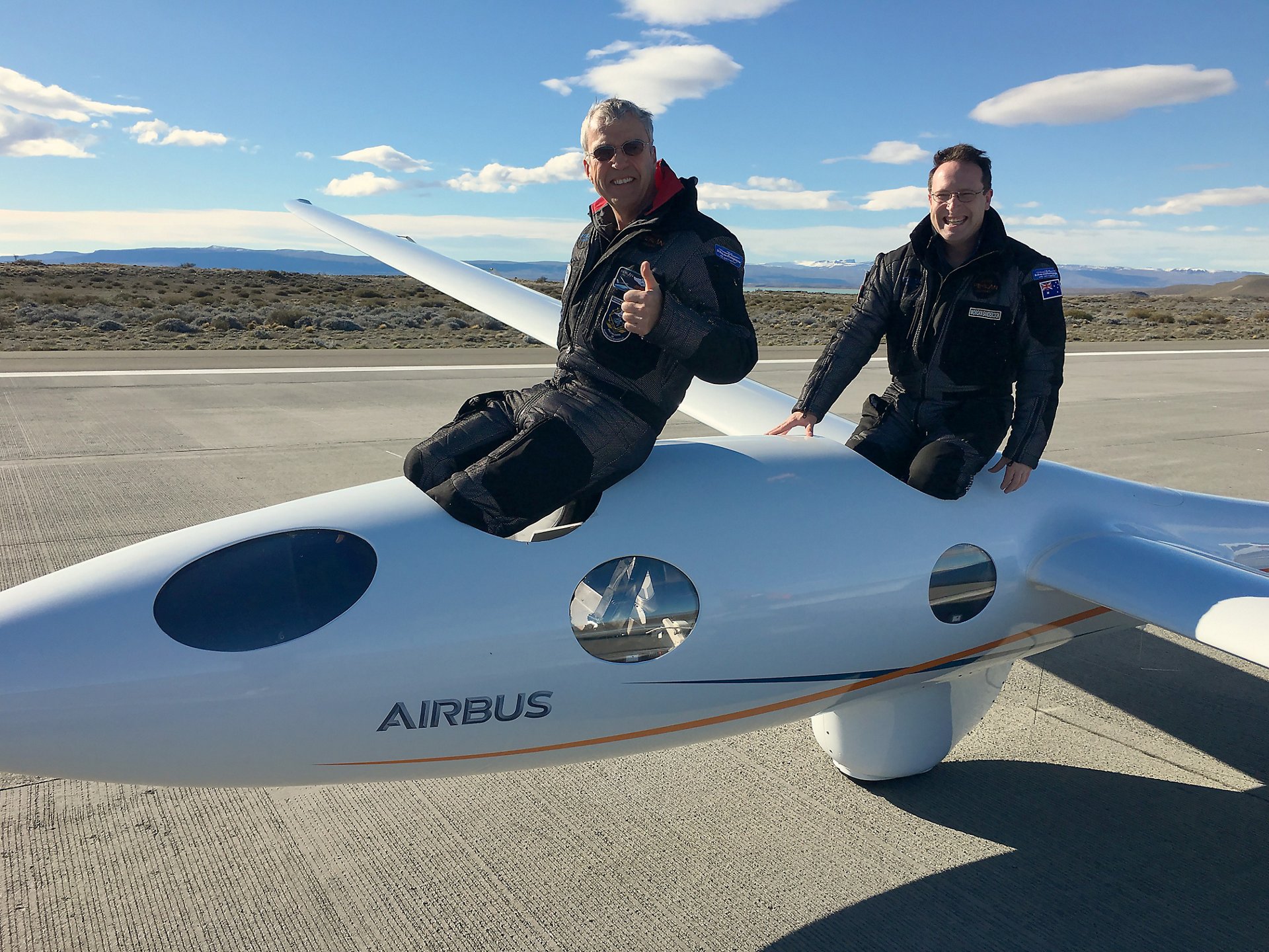 Airbus Perlan Mission II pilots Jim Payne (left) and Morgan Sandercock emerge from the cockpit after setting a new glider world altitude record Sept. 3, soaring to 52,172 feet in the pressurized craft that was carried aloft by rare “stratospheric mountain waves” in the Andes Mountains near El Calafate, Argentina. Photo by Jackie Payne, Perlan Project. 