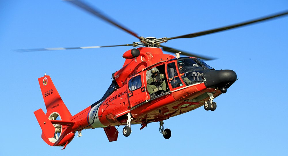 An in-flight AS365 N3+ helicopter configured for search and rescue (SAR) operations.