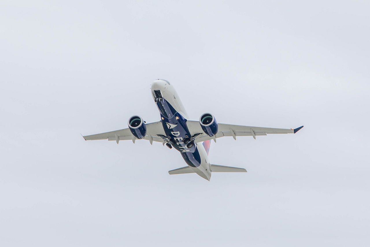 An Airbus A220-100 in Delta Air Lines’ livery ascends after takeoff.