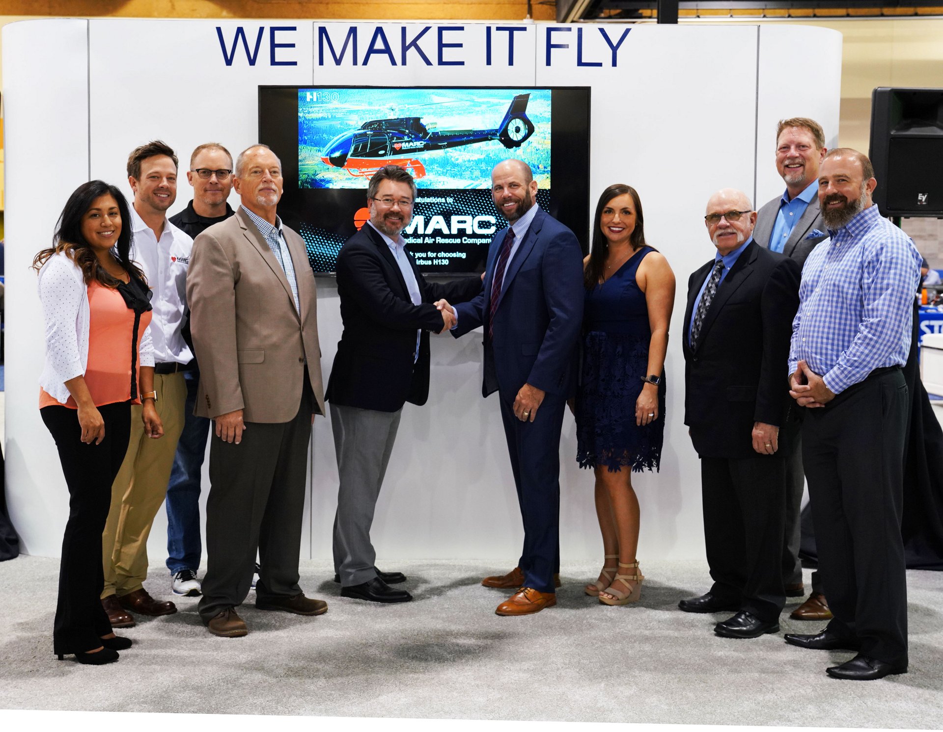 Chris Emerson, Airbus Helicopters Inc. President,  shakes hands with Paul “Monty” Renfro, CEO of MARC, along with the Airbus Helicopters Inc. and MARC teams.