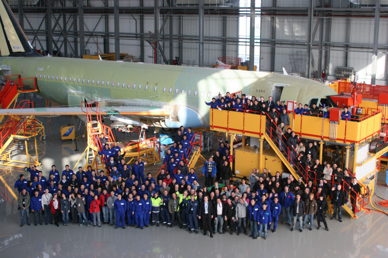 Employees at Airbus’ A320 Family final assembly line in Tianjin, China mark the facility’s 2008 inauguration with a group photo.  