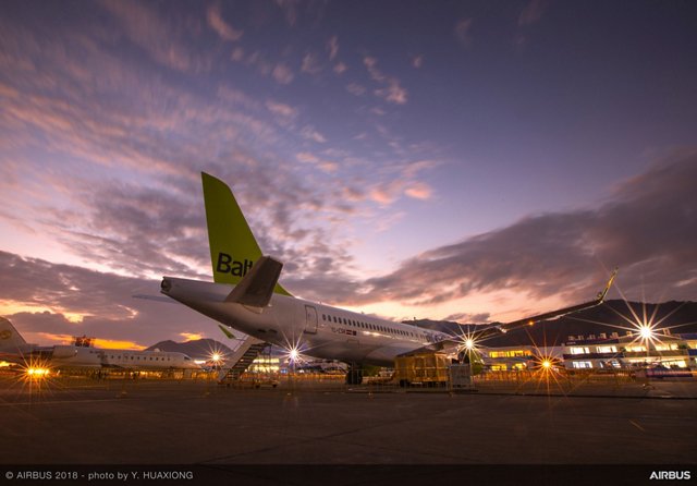 A220-300 on ground with sunset