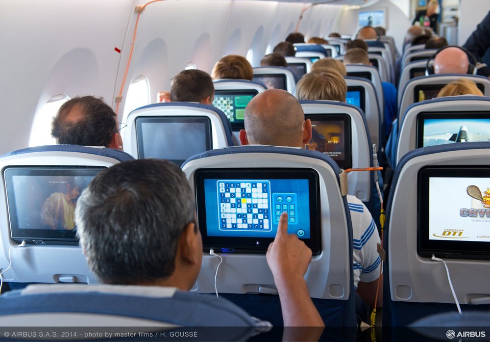 Passengers on an A350 XWB interact with individual in-flight entertainment systems 