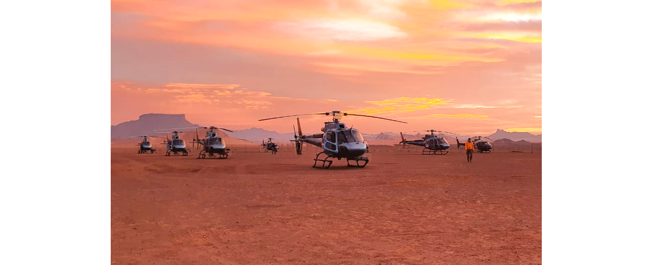 A group photo of the H125s and H130s operated by The Helicopter Company at the 2021 Dakar Rally. 
