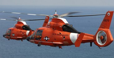 Two Coast Guard HH-65 Dolphin helicopters from Air Station Miami in formation