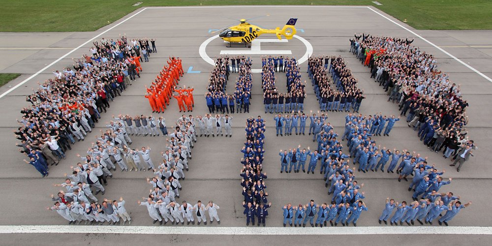 Airbus employees join in formation to mark delivery of the 1,000th EC135 helicopter (later re-designated H135).  