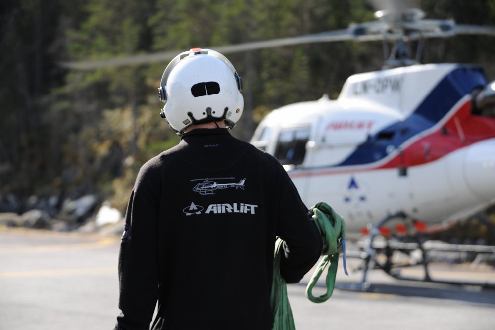 An airlift team member approaches an H125 helicopter  