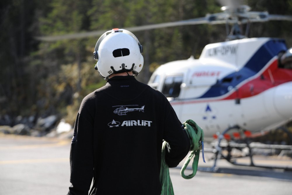 An airlift team member approaches an H125 helicopter