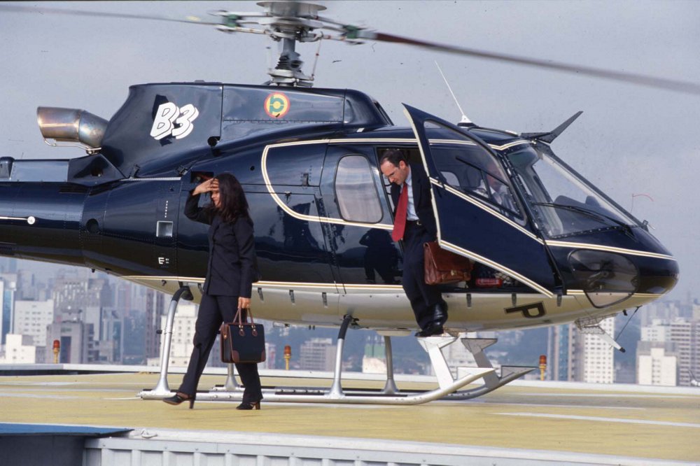 Passengers exit an Airbus H125 helicopter configured for private and business aviation