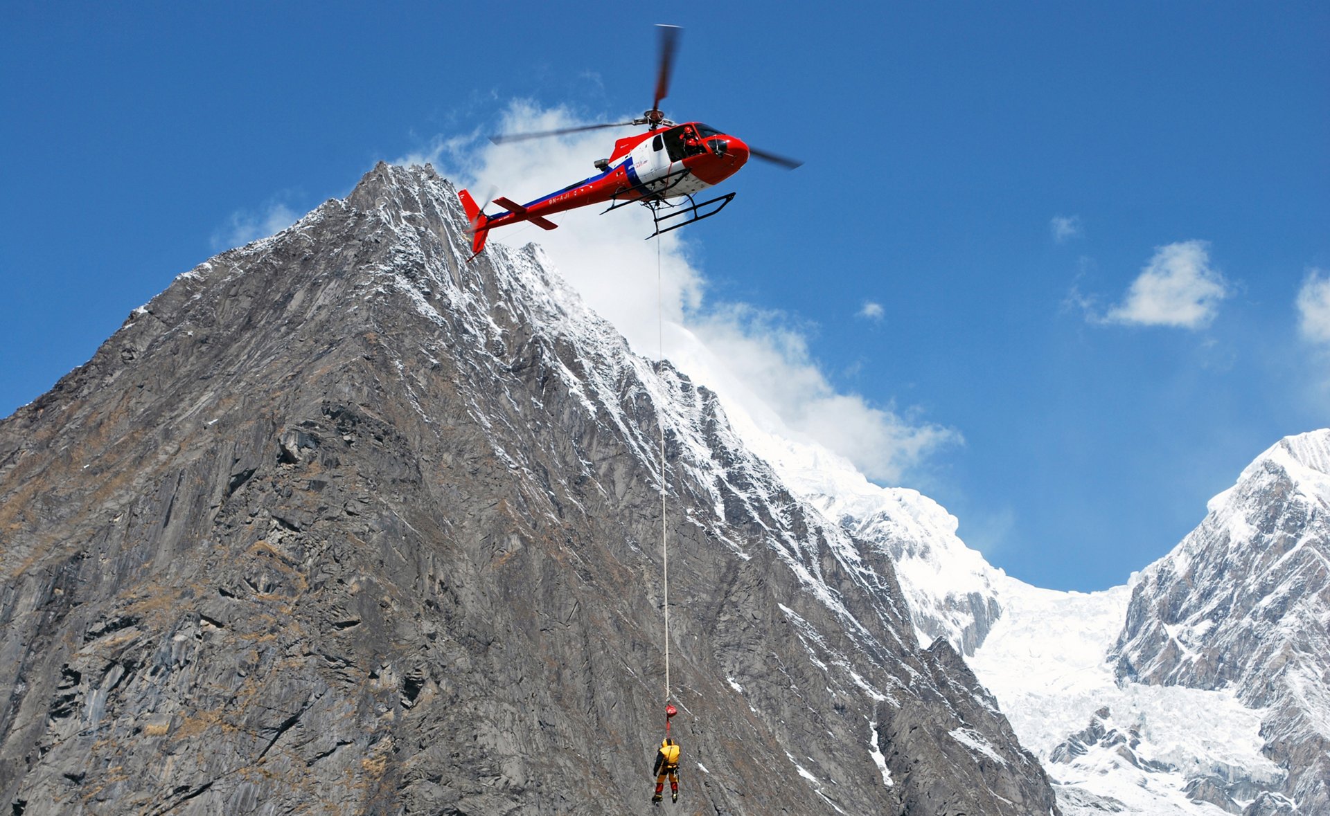 Pilots and helicopters carry out thousands of mountain rescues in the Himalayas annually. Pictured here, an H125 from Fishtail Air performs a rescue mission.