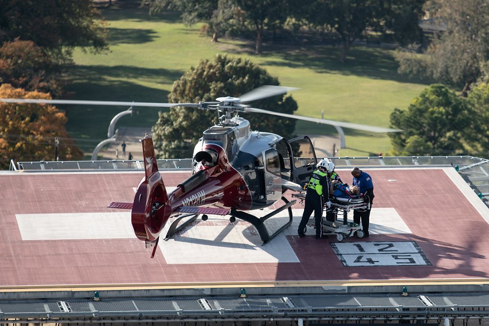 A patient is unloaded from an Airbus H130 helicopter outfitted for air ambulance operations 
