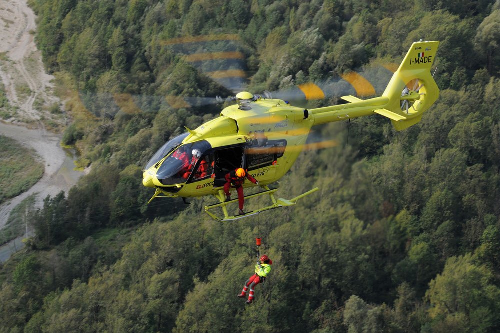 An Airbus-built Elifriulia H145 helicopter winches a person during HEMS (Helicopter Emergency Medical Services) training.