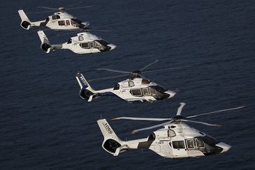 Four H160s in flight
