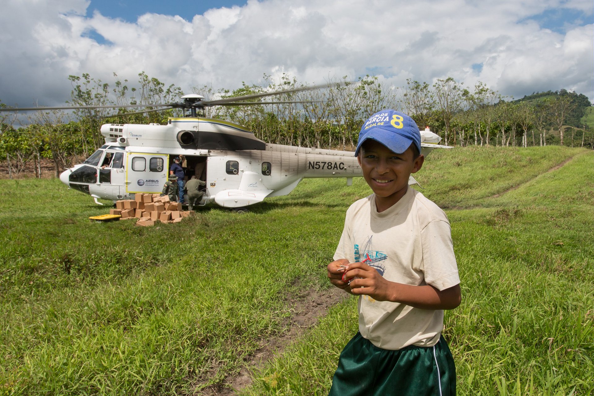 Humanitarian relief supplies are unloaded from an Airbus H215M military helicopter.