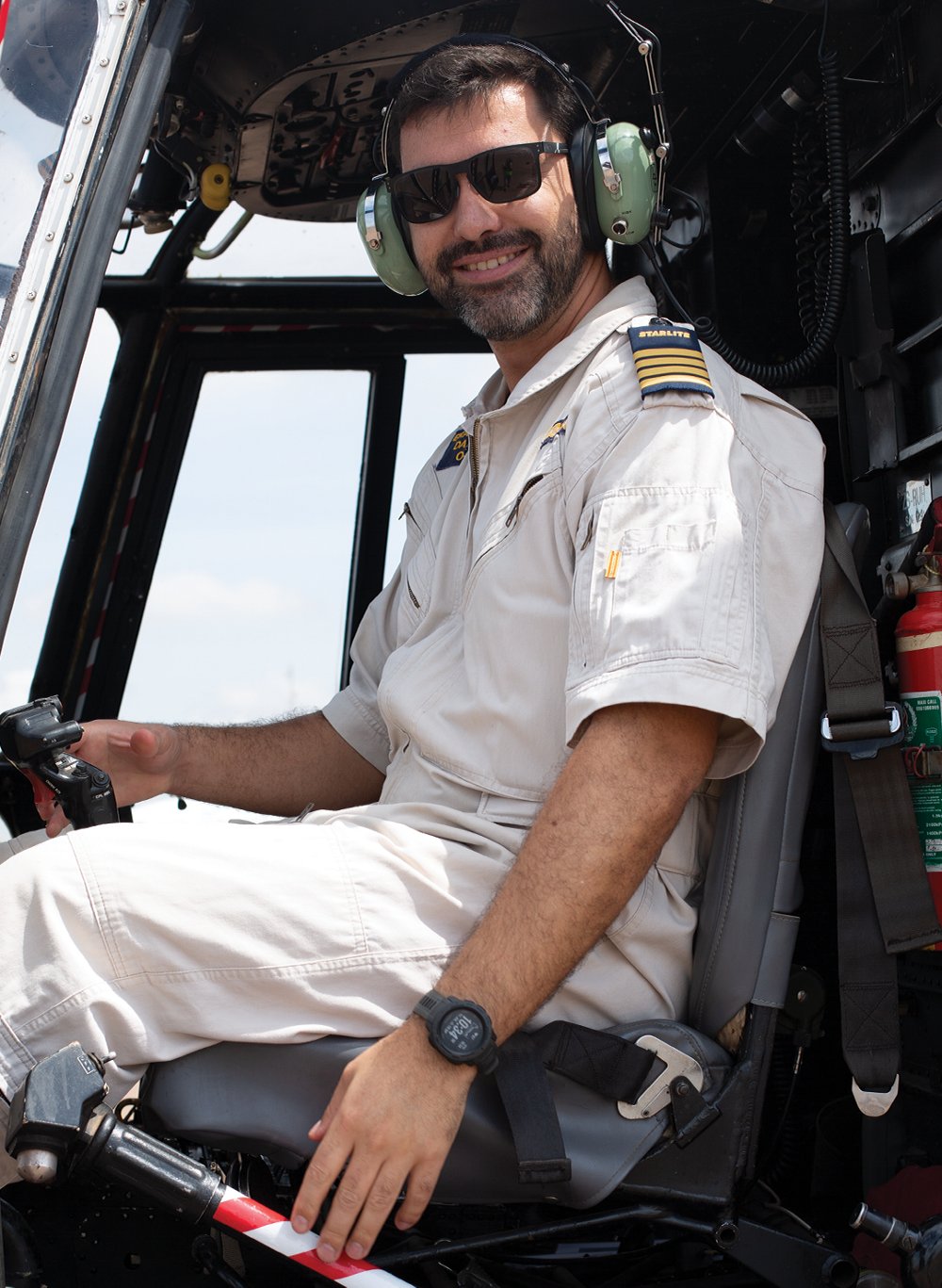Starlite MEDEVAC pilot Captain Daniel Erasmus is shown behind the controls of a helicopter. 