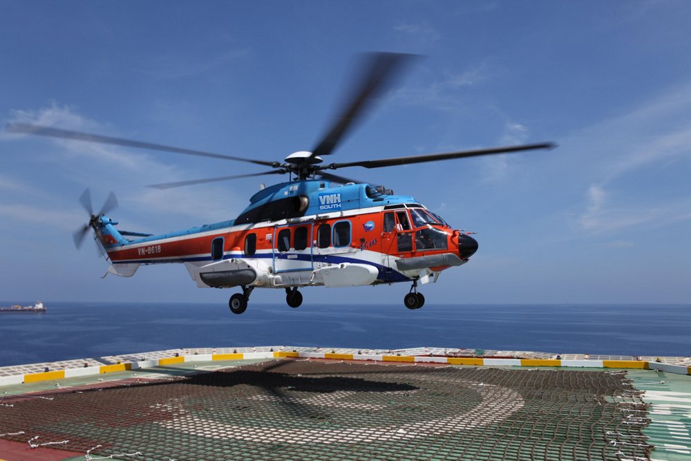 An Airbus H225 helicopter delivered to VNH South hovers over a helipad. 