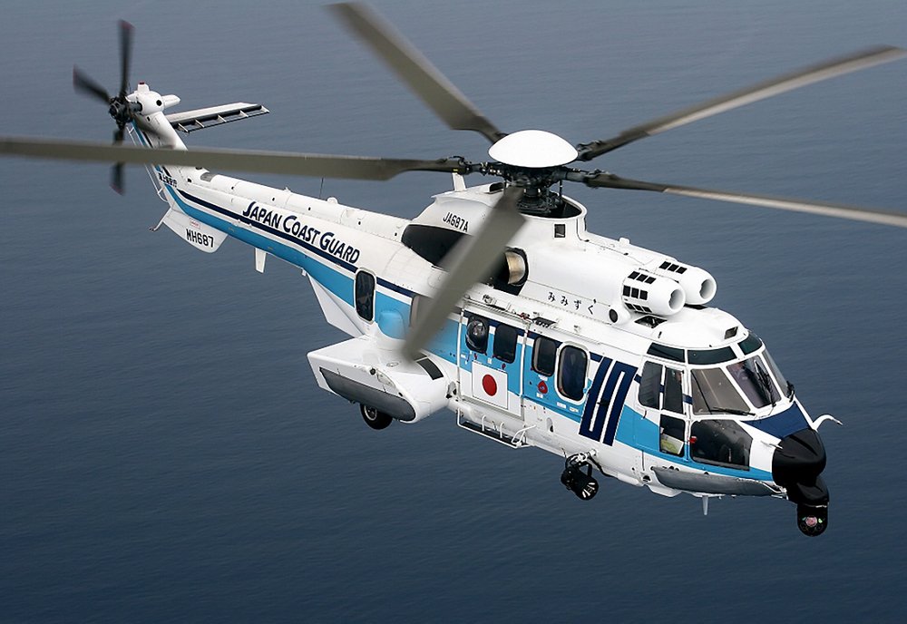 Side view of an in-flight Super Puma helicopter operated by the Japan Coast Guard. 