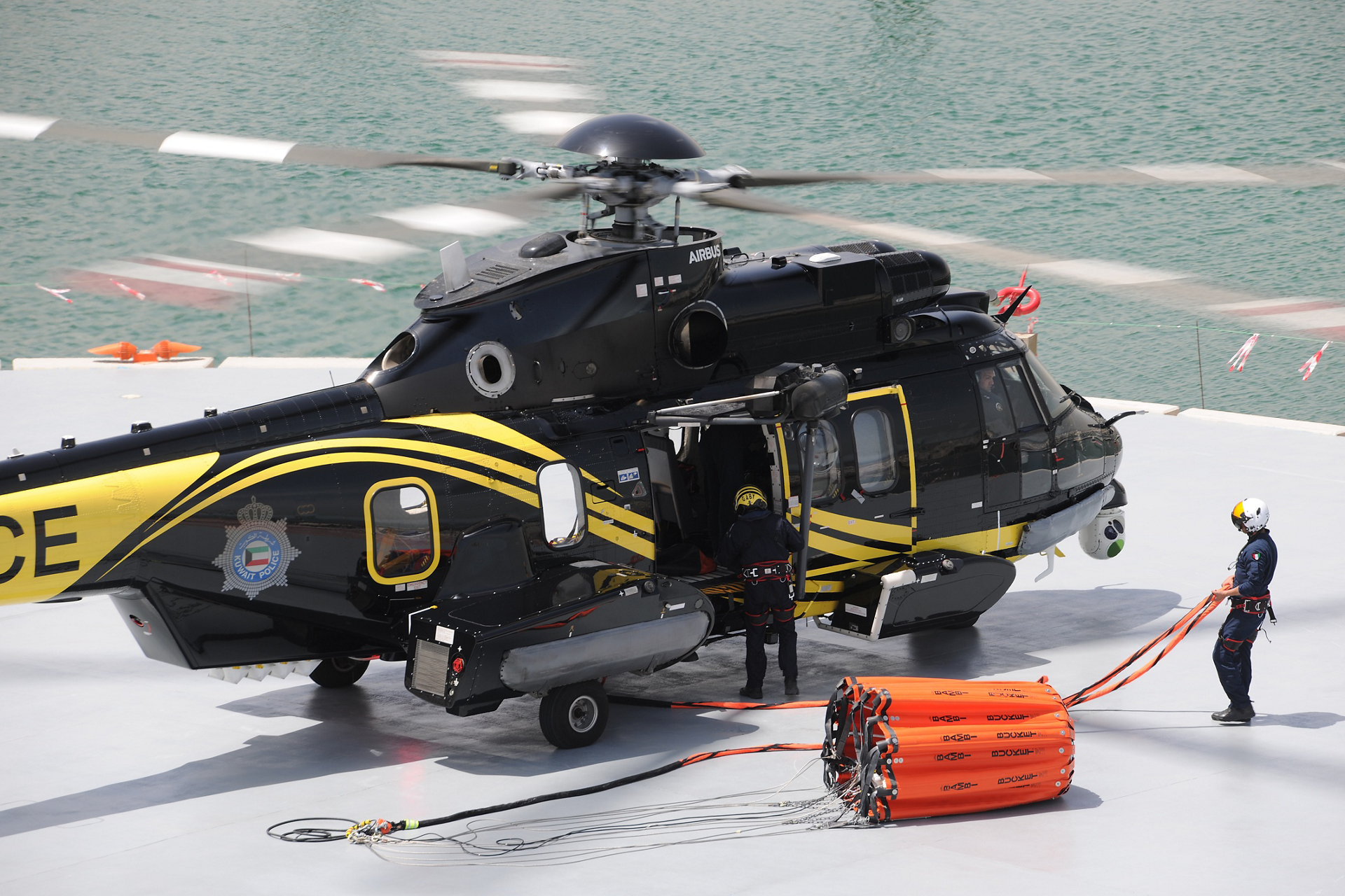 A bucket-type water dispersal system is readied for use on one of the Kuwait Ministry of Interior’s H225 helicopters. 