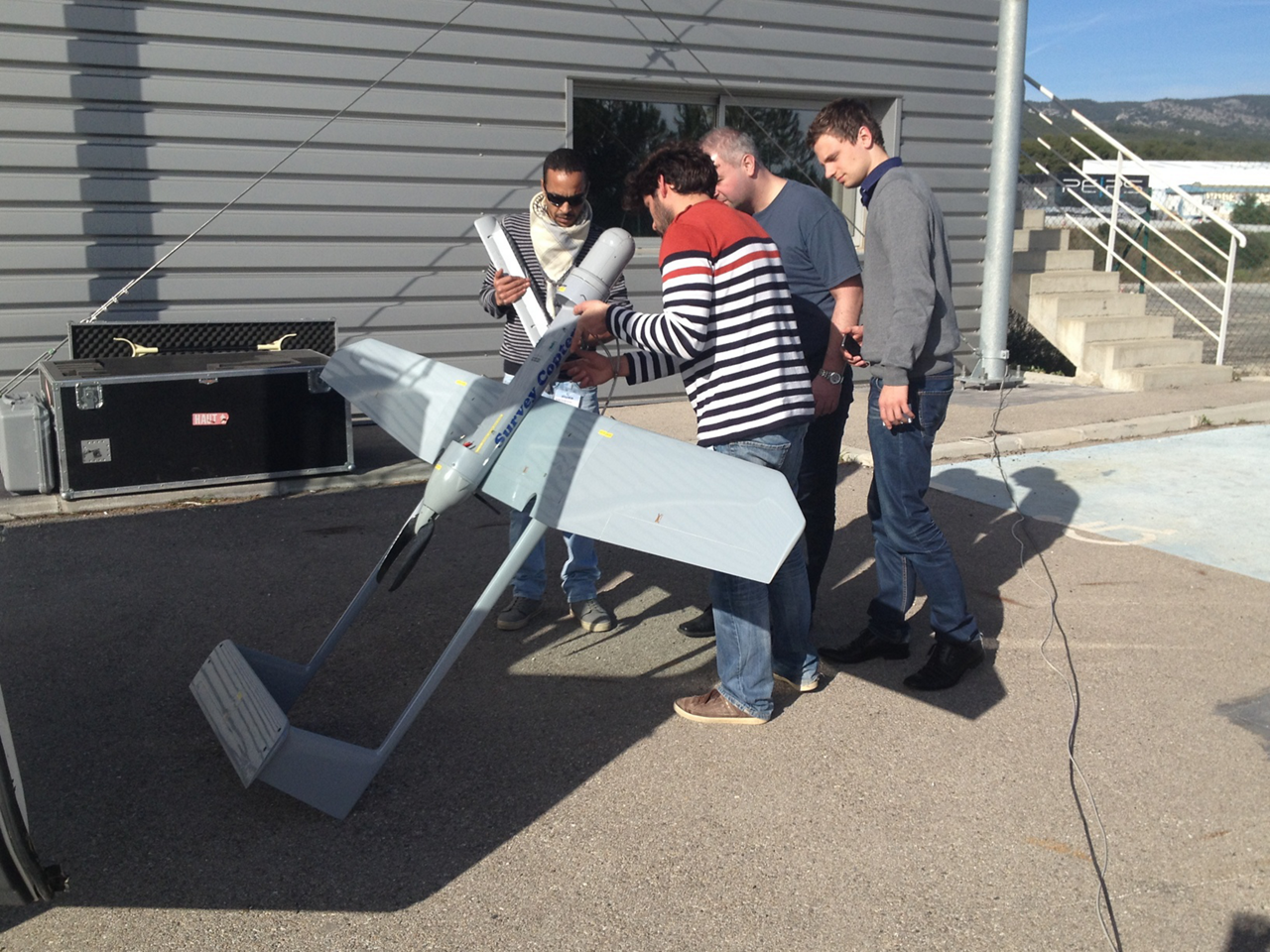An unmanned aerial vehicle (UAV) is examined before flight.   