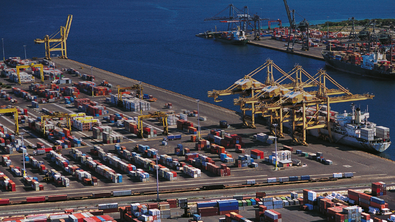 A busy port area with many shipping containers.  