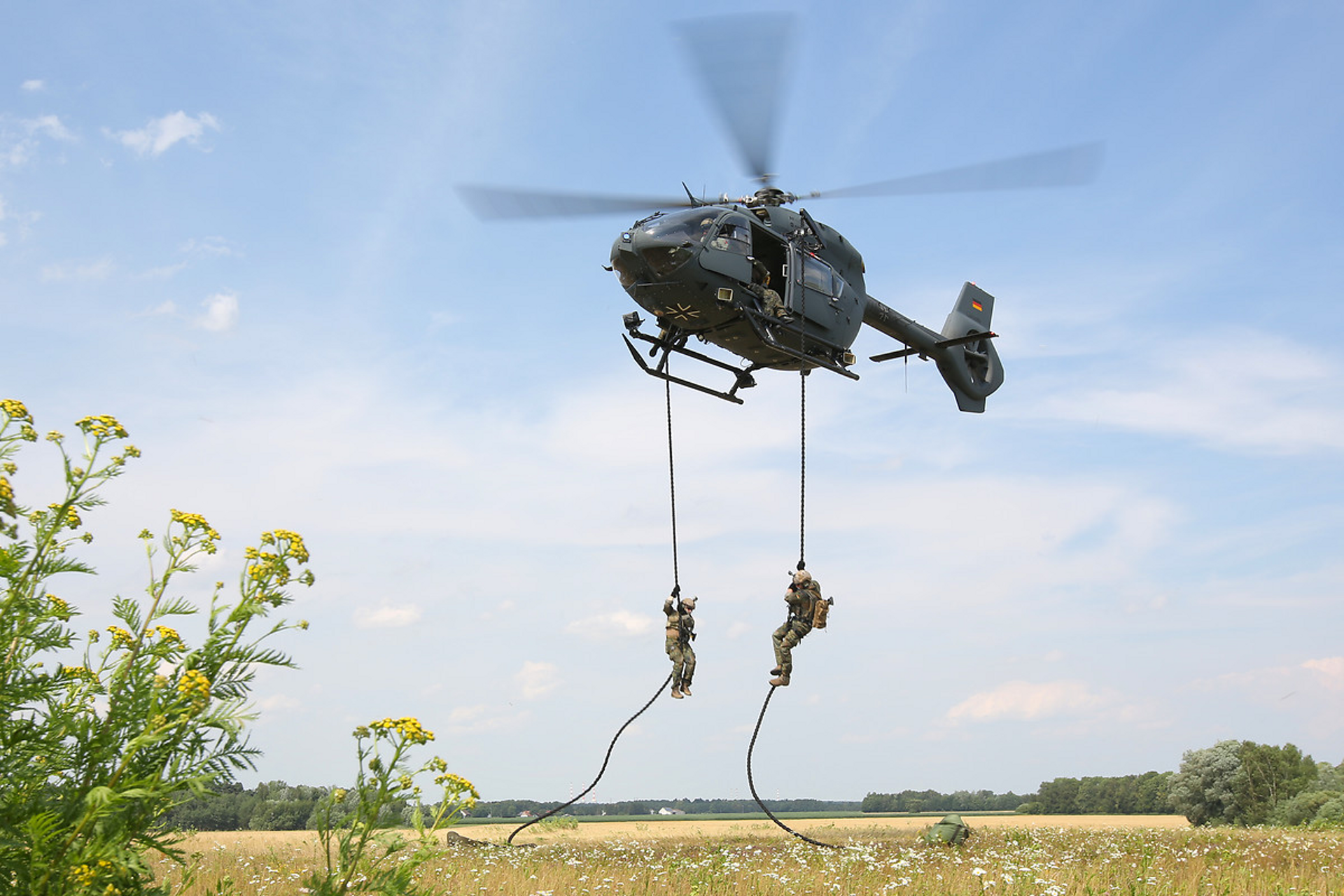Military personnel rappel from an H145M operated by Germany.
