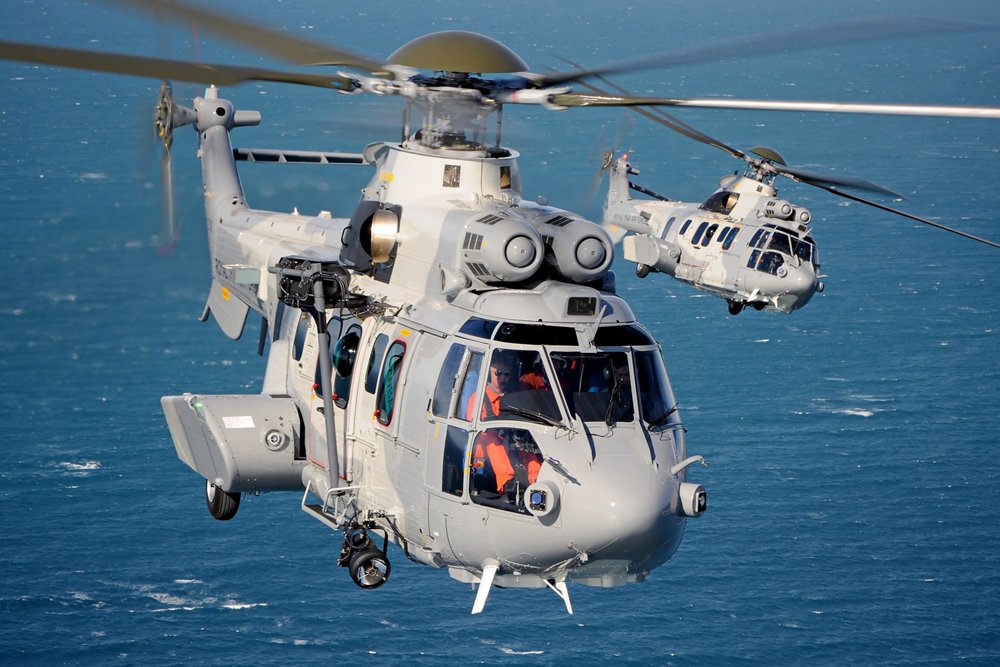 In-flight view of two Airbus H225M military helicopters delivered to the Republic of Singapore Air Force. 