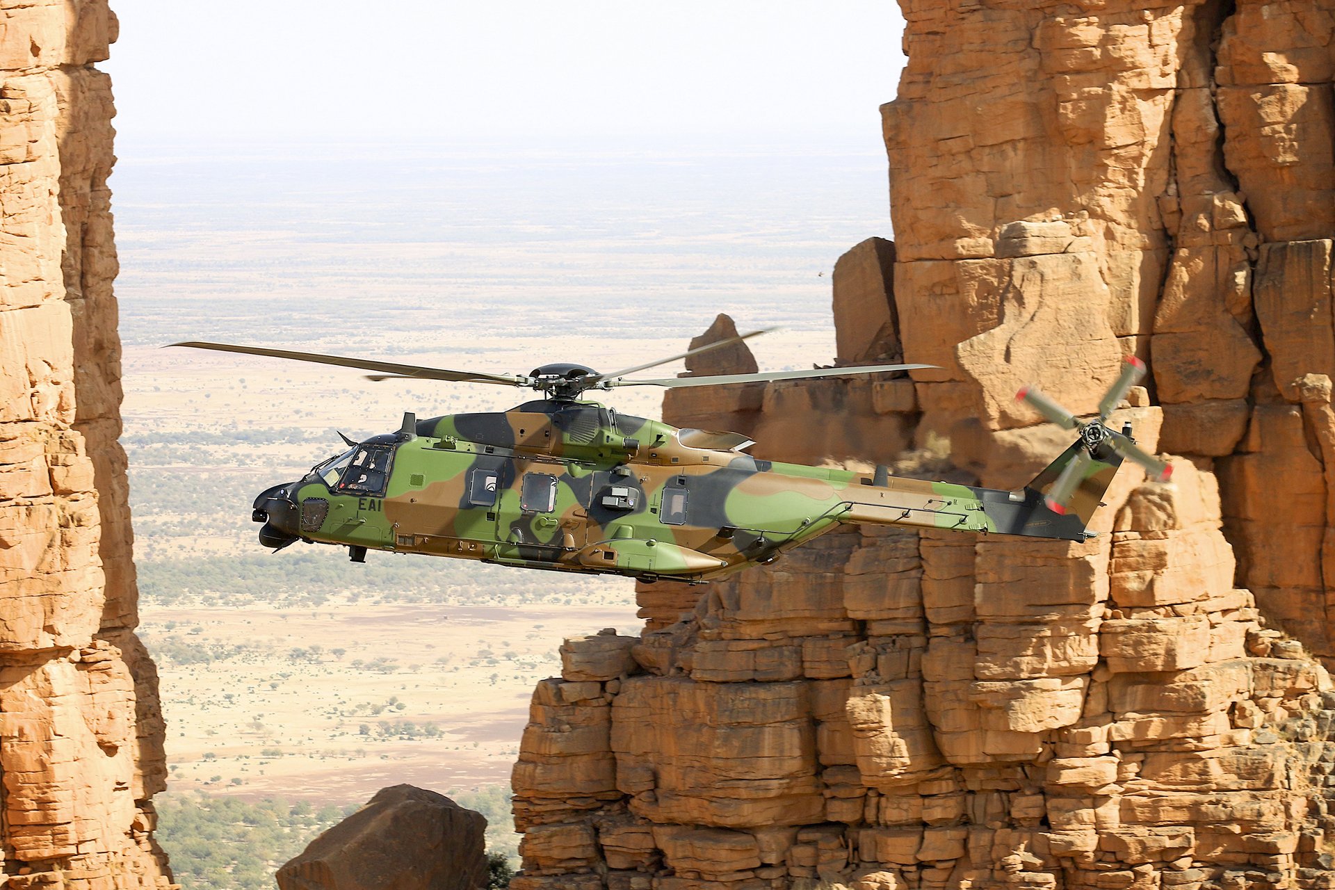 An NH90 operated by the 1st Combat Helicopter Regiment (RHC) of the French Army Light Aviation (ALAT) unit is shown in flight. 