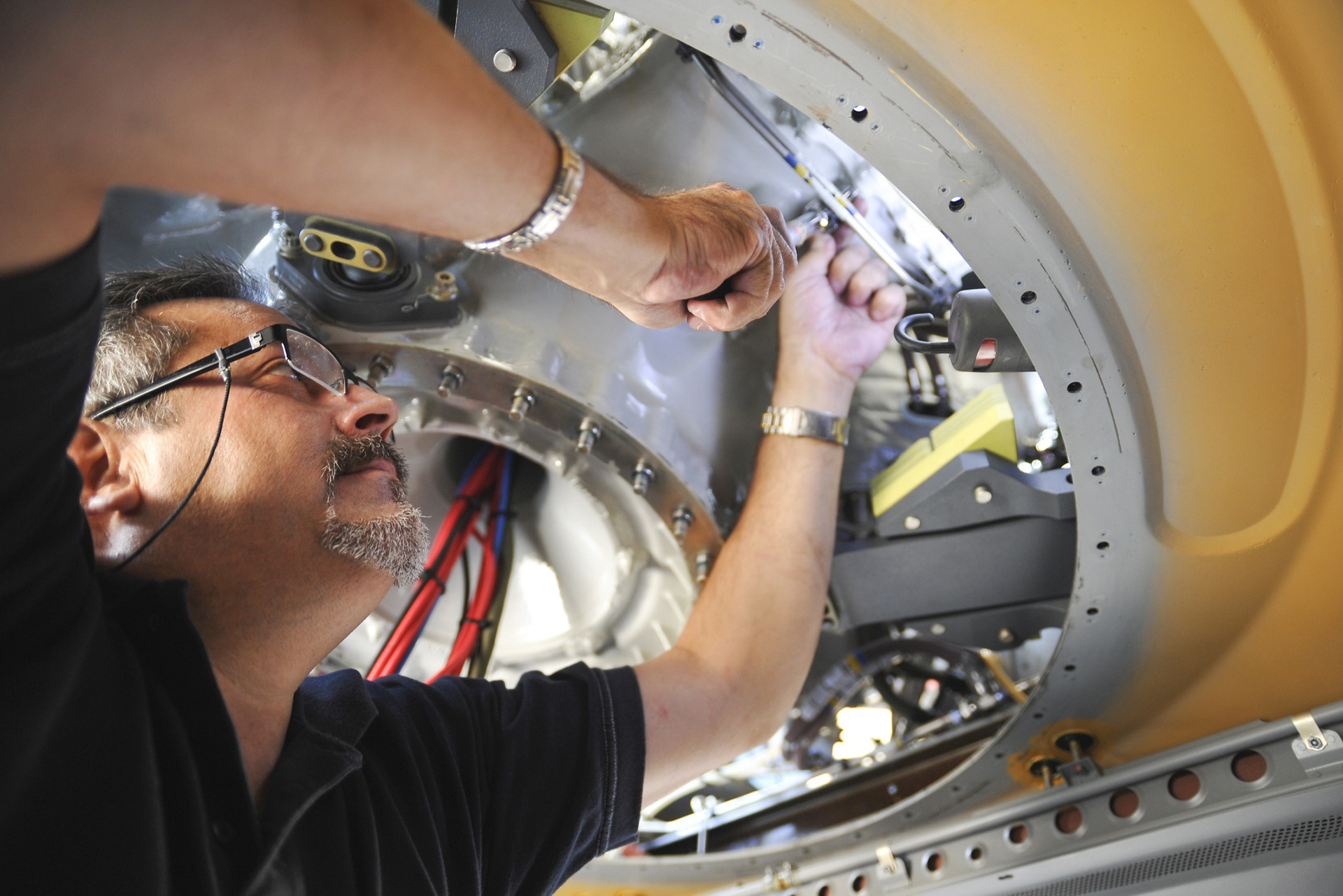 A close-up view of maintenance performed on an NH90 military helicopter.