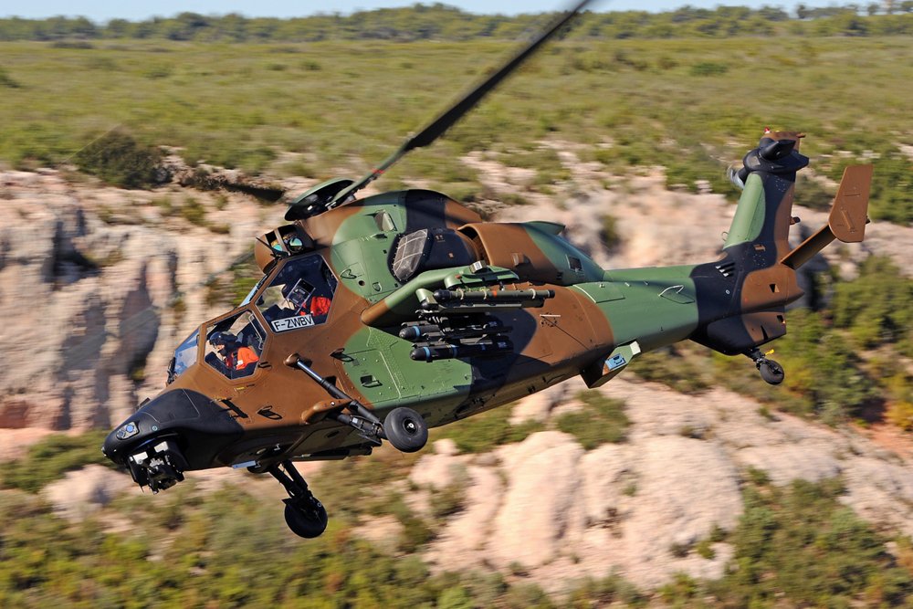 A Tiger helicopter in the HAD attack configuration is shown in flight.  