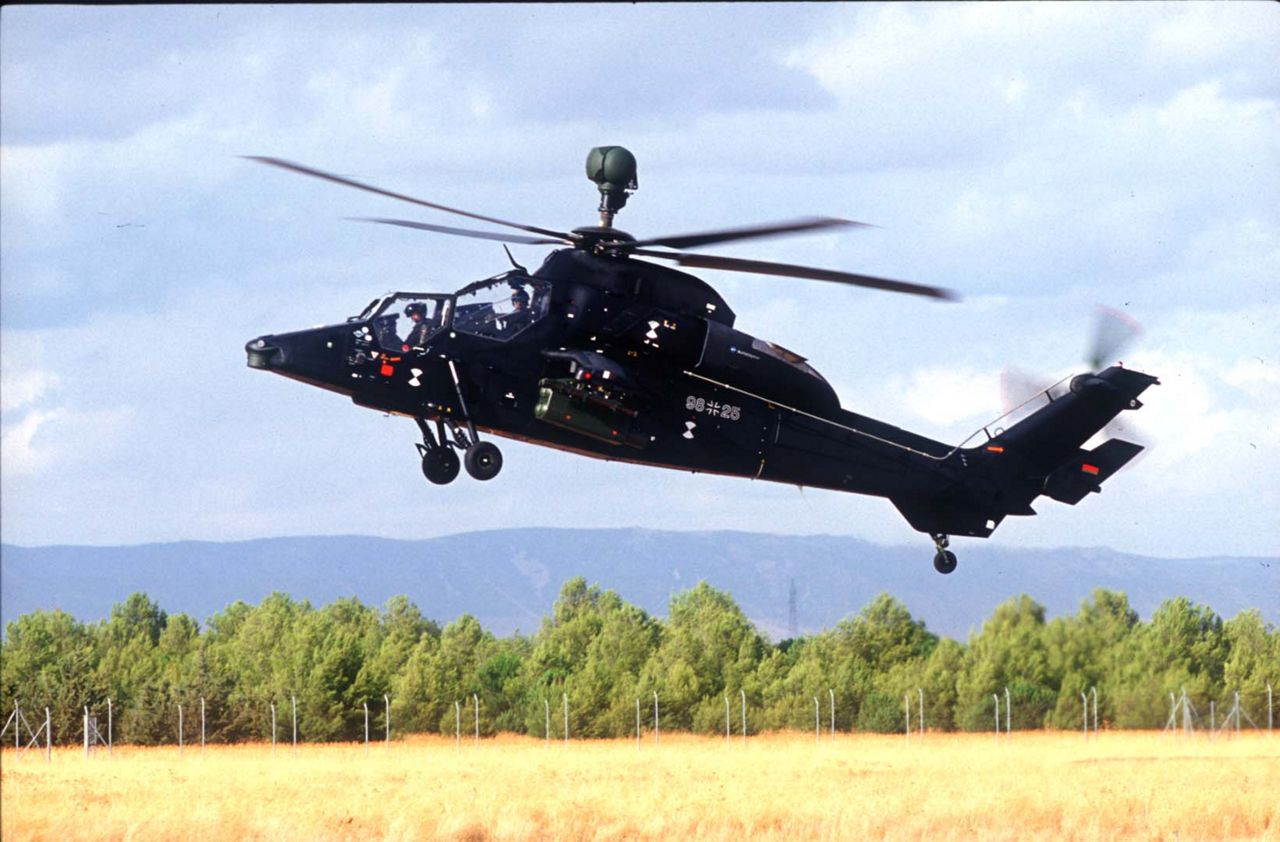 A Tiger HAD helicopter takes off from an unprepared field.