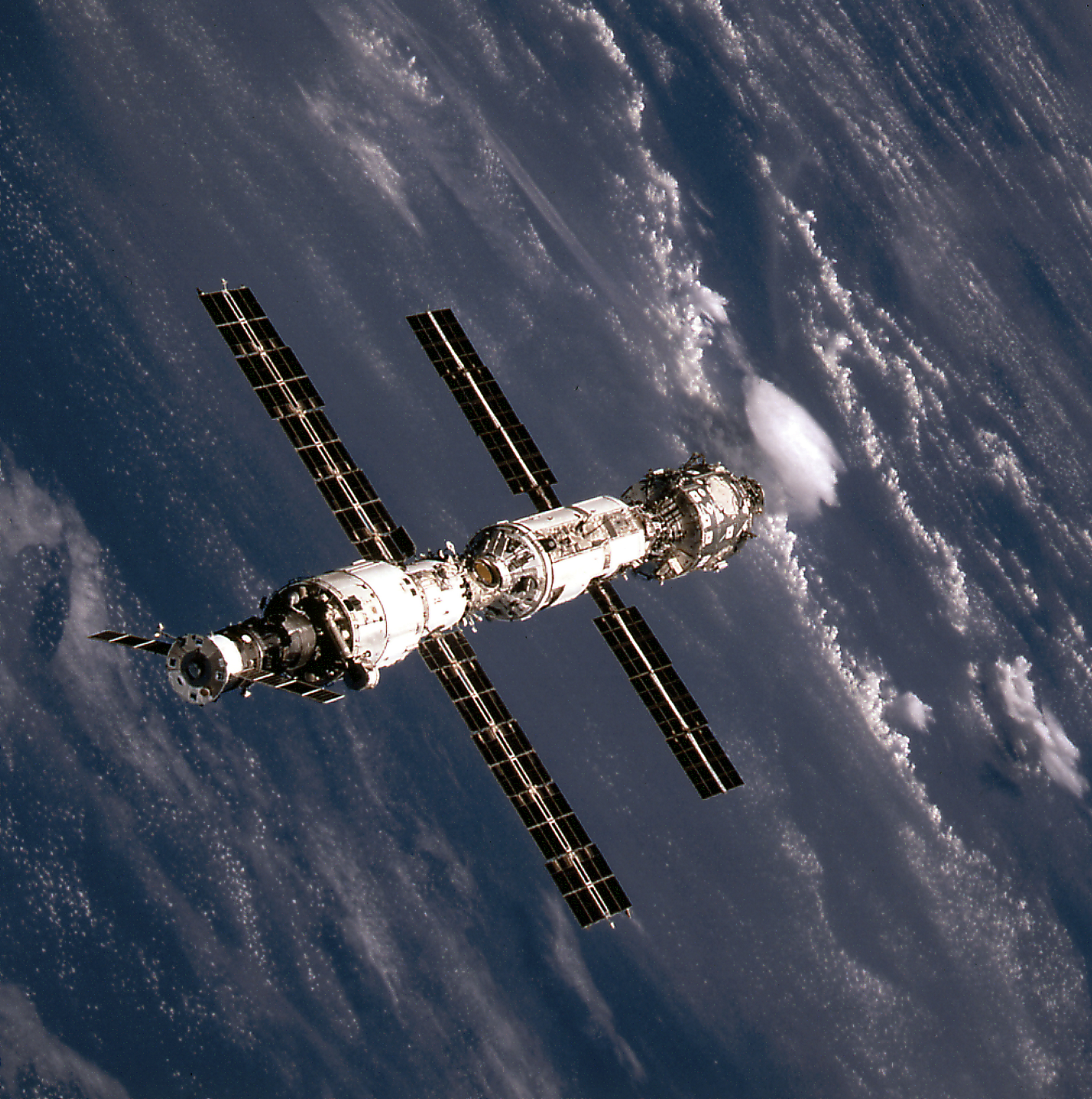 This image of the International Space Station (ISS) was taken when Space Shuttle Atlantis (STS-106 mission) approached the ISS for docking. At the top is the Russian Progress supply ship that is linked with the Russian-built Service Module (Zvezda). The Zvezda is connected with the Russian-built Functional Cargo Block (FGB or Zarya). The U.S.-built Node 1 or Unity module is seen at the bottom. – Credit: NASA (STS 106 was in Sept. 2000)