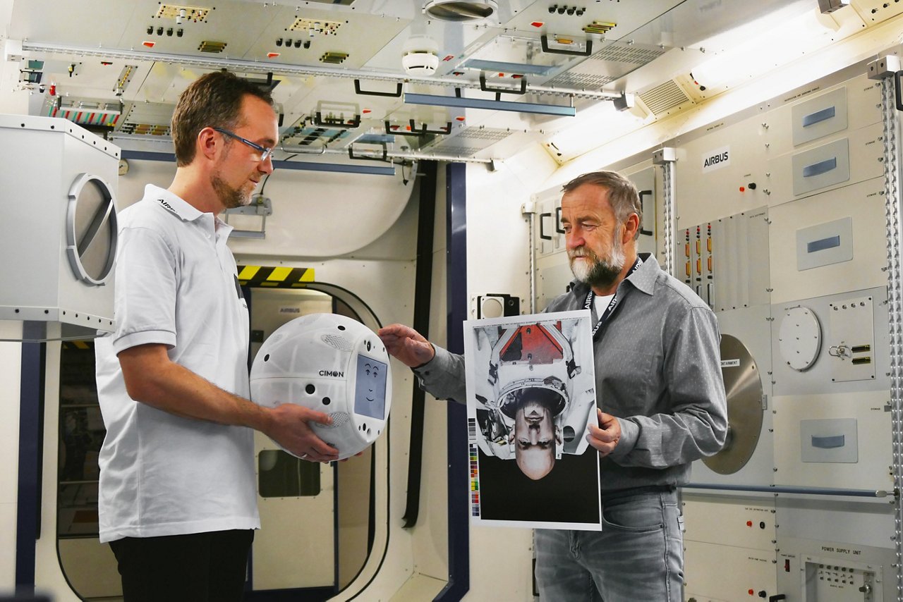 Identifying Alexander Gerst - CIMON Project Manager Till Eisenberg (left) and Josef Sommer, CIMON GNC Team Leader at Airbus are testing CIMON with images of Astronaut Alexander Gerst 