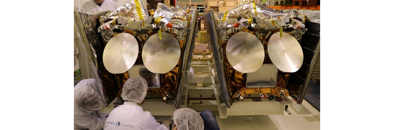 An engineer’s view of two Airbus-produced OneWeb satellites being prepared for transport to the launch site.  
